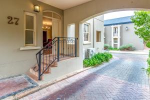 a home with an archway leading to the front door at L'ermitage - Franschhoek Chateau & Villas in Franschhoek