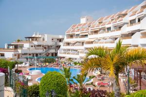 a view of a resort with a swimming pool and palm trees at Luxury Apartaments in Costa Adeje, Los Geranois in Adeje