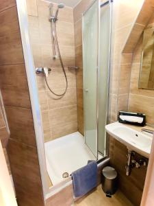 a bathroom with a shower and a sink at M-Hotel in Stuttgart