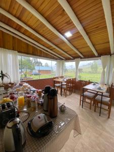 a dining room with a table with food on it at Chalé do Lago Urupema SC in Urupema