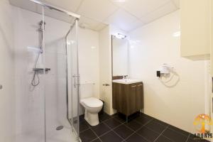 a bathroom with a toilet and a glass shower at Adonis Dijon Maison Internationale in Dijon +22 photos
