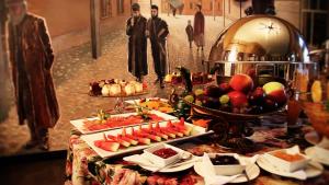 a buffet with appetizers and fruit on a table at Hotel Ester in Kraków