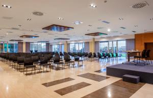 a conference room with chairs and tables and windows at Hotel Macià Real De La Alhambra in Granada