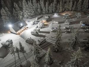 an aerial view of a parking lot with cars in the snow at Camp Gorący Potok- parcele kamperowe in Szaflary