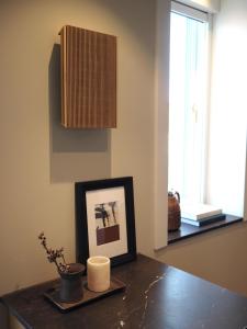 a table with a picture and a candle on it at Hypernym Hotel & Suites in Copenhagen