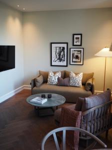 a living room with a couch and a table at Hypernym Hotel & Suites in Copenhagen