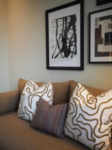 a couch with two pillows on top of it at Hypernym Hotel & Suites in Copenhagen