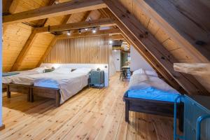 a bedroom with two beds in a attic at Zagroda Swołowo in Słupsk