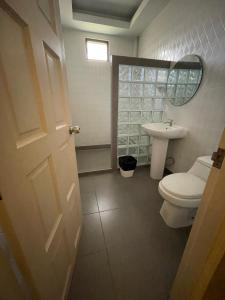 a bathroom with a toilet and a sink at Loft House Resort Pattaya in Jomtien Beach