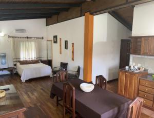 a living room with a bed and a dining table at Departamento Porá in Puerto Iguazú