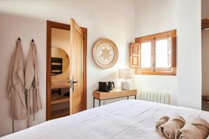a bedroom with a white bed and a window at Finca las Calmas boutique hotel & retreats in Moraleda de Zafayona