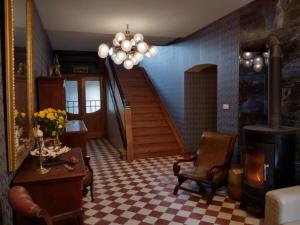 a living room with a staircase and a table and chair at Sunny Bear Bed & Breakfast in Jelenia Góra