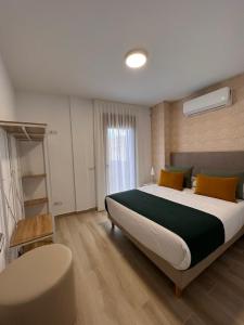 a bedroom with a large bed and a window at Apartamentos Doña Emilia in Adeje +17 photos