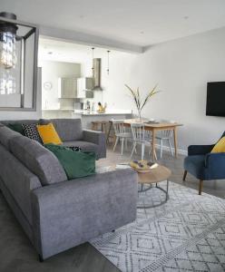 a living room with a gray couch and a table at 45a Oxford Street in Harrogate