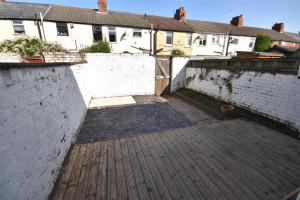 an empty courtyard in a house with brick walls at 2 bedroom house in Hoylake - Golf Open in Hoylake
