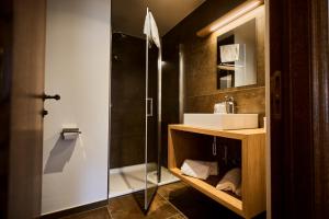 a bathroom with a sink and a shower at Hôtel La Métairie in Trois-Ponts +27 photos