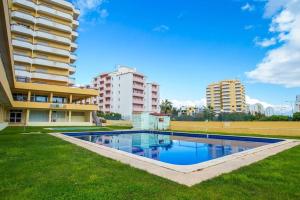 una piscina frente a un edificio en Praia da Rocha - 1Bdr - 2 Pools - Beach at 300m, en Portimão