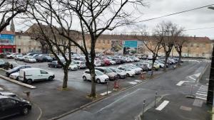 a parking lot full of cars in a city at Votre Escale - Calliopé in Niort