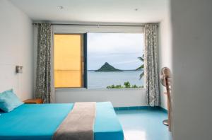 a bedroom with a window with a view of the ocean at villa piscine à louer a DIEGO SUAREZ. MADAGASCAR in Antsiranana