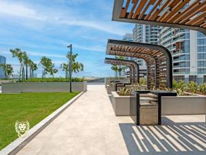 a walkway in a city with a park at Luxury 1BR Apt with Unobstructed Dubai Frame View in Dubai