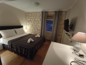 a bedroom with a bed with two towels on it at Room No3 in Trogir