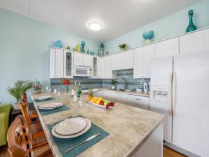 a kitchen with white cabinets and a large kitchen island at Penthouse With Fabulous Ocean View Near Waikiki Beach in Honolulu