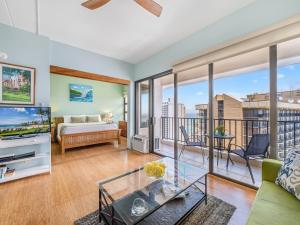 a living room with a king bed and a large window at Penthouse With Fabulous Ocean View Near Waikiki Beach in Honolulu