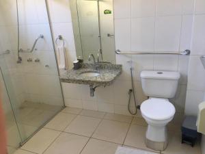 a bathroom with a toilet and a shower and a sink at Klinn Hotel in Tanabi +7 photos