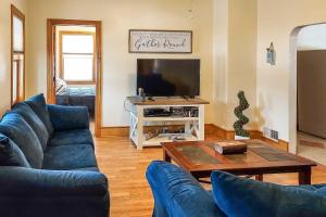 a living room with two blue couches and a coffee table at All-Season Grand Haven Getaway with Deck! in Grand Haven