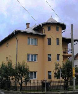 a large yellow building with a roof at Casa Livia în inima Bucovinei in Gura Humorului