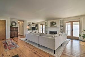 a living room with a couch and a fireplace at Bayside Deltaville Retreat with Beach and Bay Views! in Locklies