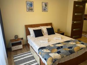 a bedroom with a bed with a quilt on it at Bavaria Apartament in Mangalia