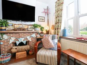 a living room with a tv on a brick fireplace at Solent Sea View in Fareham