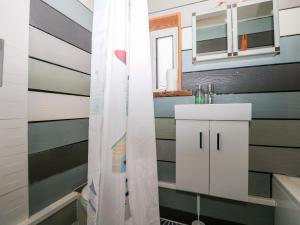 a bathroom with a shower curtain and a sink at Solent Sea View in Fareham