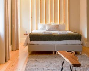 a bedroom with a bed with a large window at Quinta de Carcavelos Natures Home in Amarante