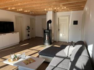 a living room with a couch and a wood stove at Ferienwohnung Blick Thyratal in Stolberg