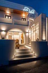a facade of a building at night with lights at Deluxe Hotel Santorini in Fira