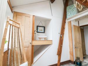 a tiny house with a staircase and a wooden door at Cowes View Cottage in Fareham