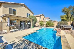 a swimming pool in the backyard of a house at Bella Casa Coolidge Home with Pool and Hot Tub! in Coolidge