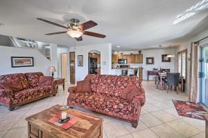 a living room with two couches and a kitchen at Coolidge Getaway with Pool, Hot Tub and Fire Pit! in Coolidge