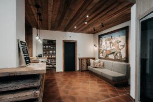 a living room with a couch and a painting on the wall at Alpenappartements Cristall in Ehrwald