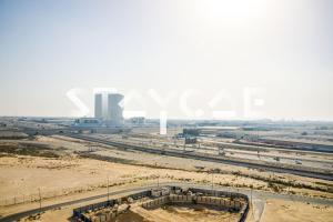 an aerial view of a city with a highway at Staycae Holiday Homes - Suburbia in Dubai