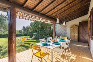 a dining table and chairs on a patio at Residence Elena 19-B by Wonderful Italy in Soiano del Lago