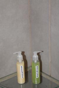 two bottles of soap sitting next to a wall at Departamento de la Bahia in Bahía Blanca