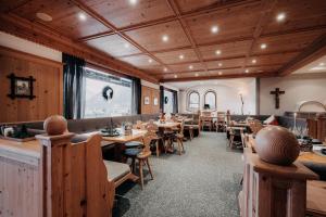 a dining room with wooden tables and chairs at Alpenappartements Cristall in Ehrwald