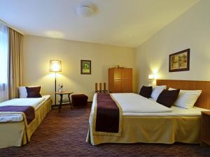 Postel nebo postele na pokoji v ubytování Comfort Hotel tom Kyle