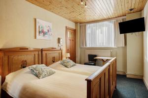 Postel nebo postele na pokoji v ubytování Hotel Georges