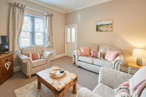 a living room with two couches and a coffee table at Host & Stay - Rose Cottage in Aldbrough