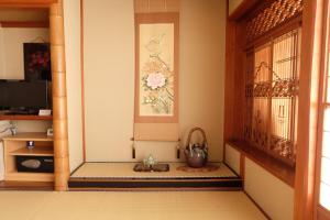 a corner of a room with a door and a window at Hinodeya in Ito