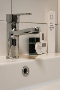 a kitchen counter with a sink with a faucet at Loft Plus Hotel's in Arnavutköy